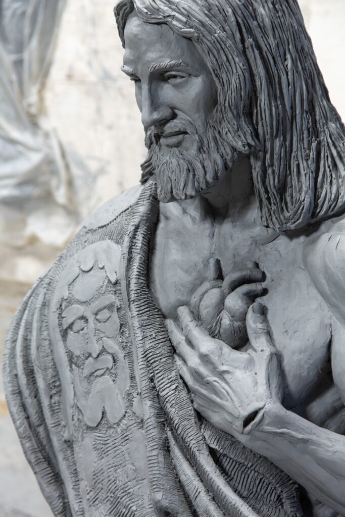 Close-up detail of the Sacred Heart of Jesus sculpture in progress.