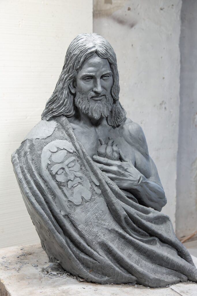 Side view of the Sacred Heart of Jesus sculpture during the creation process in Timothy Schmalz's studio.