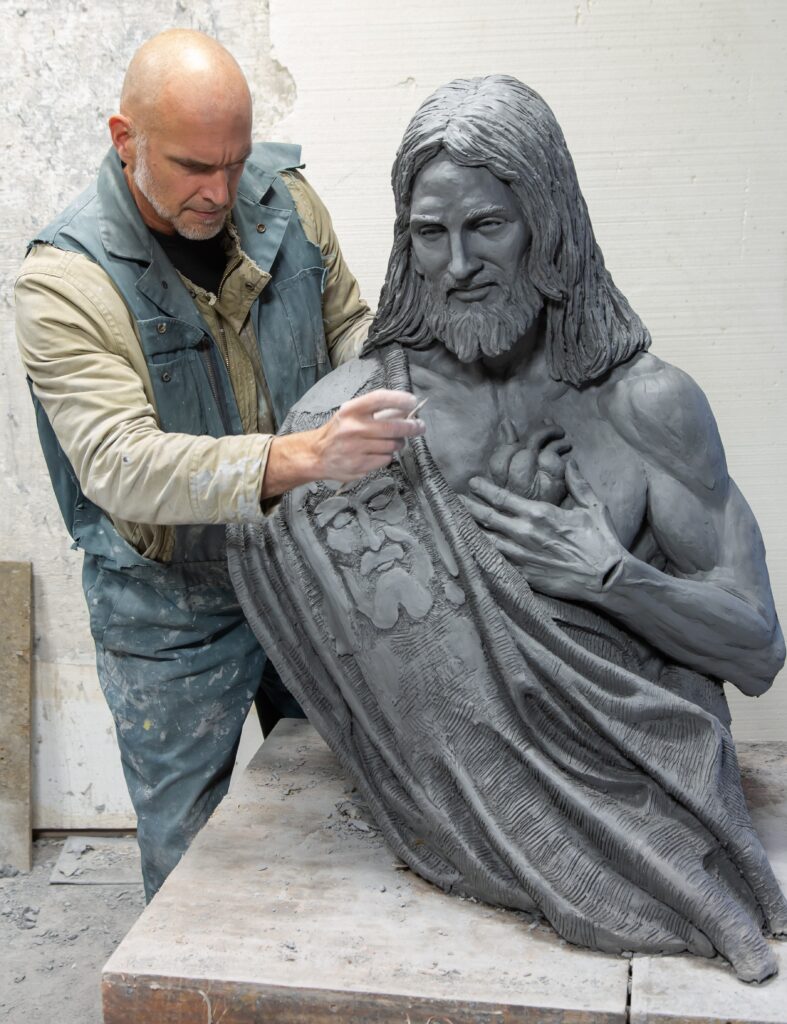 Timothy Schmalz working on the Sacred Heart of Jesus sculpture in his studio.